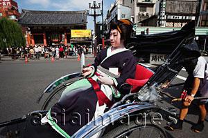 Asia Images Group - Geisha in Rickshaw in front of Asakusa Kannon Temple. Tokyo, Japan