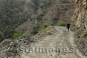 Asia Images Group - Older man walking on dirt road. Himalayan mountains, India