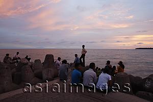 Asia Images Group - Small crowd gathered at the sea shore at sunset, Mumbai, India