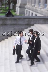 Asia Images Group - Three executives walking down a flight of steps