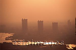 Asia Images Group - Thailand, Bangkok, Condominiums seen through the smog across the Chao Praya River