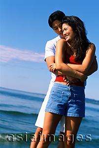 Asia Images Group - Young couple embracing on beach