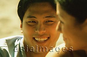 Asia Images Group - Profile of young woman smiling at young man