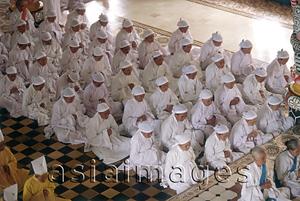 Asia Images Group - Vietnam, Tay Ninh, believers with white headbands in Cao Dai Great Temple.