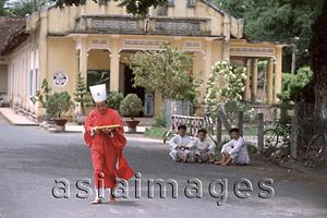 Asia Images Group - Vietnam, Tay Ninh, Cao Dai priest in red robe.