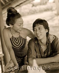 Asia Images Group - Woman with arm around man, at table