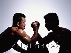 Asia Images Group - Two men arm wrestling, white background