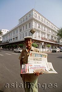 Asia Images Group - Vietnam, Saigon, newspaper vendor outside Hotel Continental