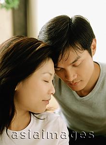 Asia Images Group - Couple with heads together, eyes closed