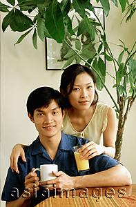 Asia Images Group - Couple with drinks at home, portrait
