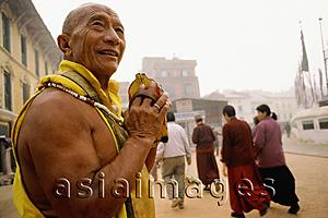 Asia Images Group - Nepal, Boudhanath, prostrator making his rounds