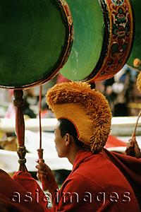 Asia Images Group - China, Szechuan (Sichuan), Kham region, Monk playing drums at Temple Puja.