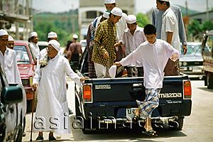 Asia Images Group - Thailand, Worshippers dress in traditional garb arrive for Friday prayers in the back of a pickup truck.