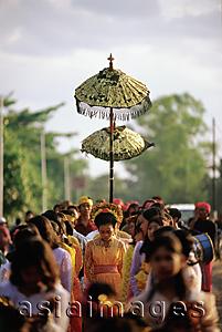 Asia Images Group - Indonesia, Lombok, a bride walking under a canopy and accompanied by female attendants, following musicians to the groom's home.