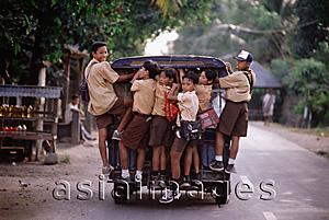 Asia Images Group - Indonesia, Lombok, Schoolboys riding on the back of a van.
