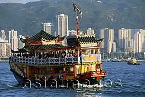 Asia Images Group - Hong Kong, Victoria Harbor, Double-decker boat, buildings in background.