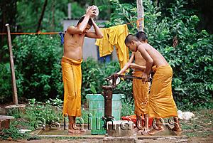 Asia Images Group - Vietnam, Mekong Delta region, Bac Lieu, Buddhist monks bathing at water pump.