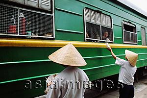 Asia Images Group - Vietnam, Locals outside the Reunification express that runs from Ho Chi Minh City (Saigon) to Hanoi