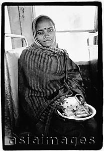 Asia Images Group - India, Dharamsala, Indian girl on bus holding Hindu icons.