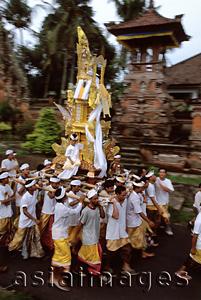Asia Images Group - Indonesia, Bali, Gianyar, Pengastian ceremony, men carrying ceremonial tower to sea. (grainy)