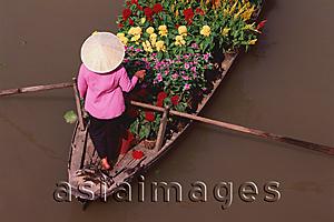 Asia Images Group - Vietnam, Can Tho, Hau river, Flower seller steering boat, floating market.