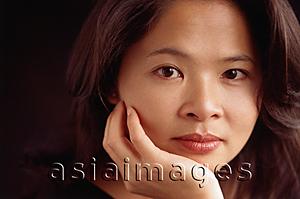 Asia Images Group - Woman looking at camera, chin on hand