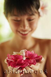 Asia Images Group - Portrait of a young woman, holding flowers
