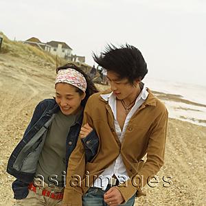 Asia Images Group - Couple walking along beach
