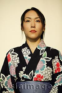 Asia Images Group - Young woman wearing a kimono.