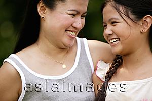 Asia Images Group - Mother and daughter looking at each other, smiling
