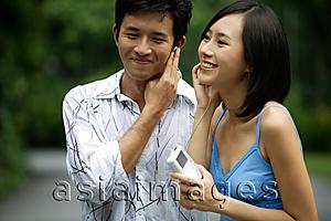 Asia Images Group - Couple listening to MP3 player