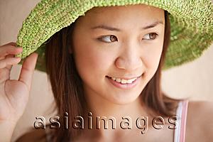 Asia Images Group - Young woman looking away, wearing hat