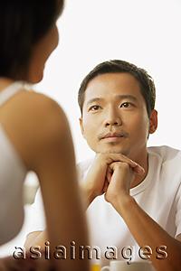 Asia Images Group - Young man and woman talking, face to face