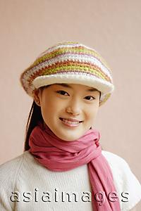 Asia Images Group - Young woman wearing cap, smiling, portrait