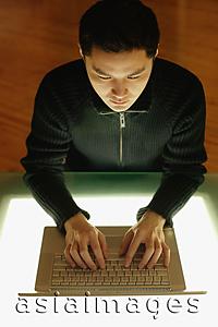 Asia Images Group - Young man using laptop, high angle view