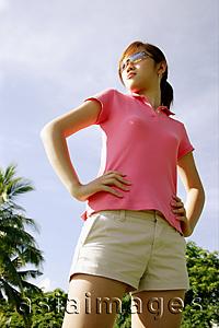 Asia Images Group - Young woman standing, hands on hips