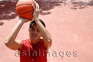Asia Images Group - Man holding basketball, aiming