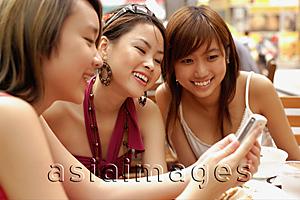 Asia Images Group - Three young women looking at mobile phone