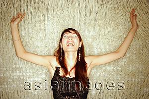 Asia Images Group - Young woman, arms outstretched, shouting