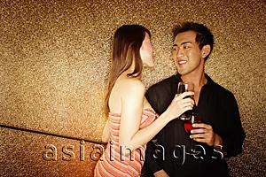 Asia Images Group - Couple standing with wine glass, face to face
