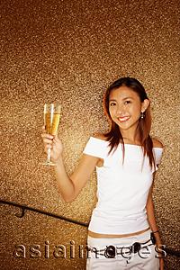 Asia Images Group - Young woman holding champagne glass, looking at camera