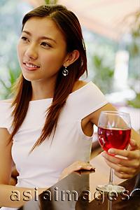 Asia Images Group - Young woman with wine glass, portrait