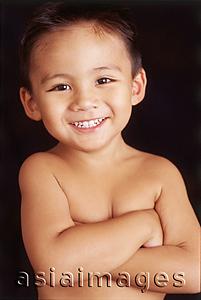 Asia Images Group - Boy looking at camera, arms crossed