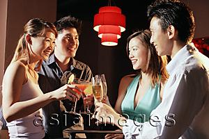 Asia Images Group - Couples holding drinks, toasting