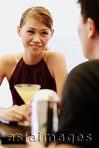 Asia Images Group - Woman facing man, drink in front of her