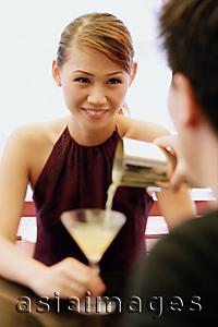 Asia Images Group - Man pouring drink for woman