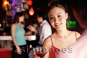 Asia Images Group - Woman facing man, looking over shoulder at camera