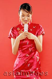 Asia Images Group - Woman holding mobile phone, text messaging