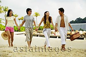 Asia Images Group - Couples on beach, holding hands and walking