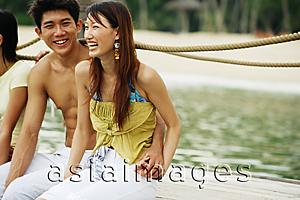 Asia Images Group - Couple on jetty, sitting side by side
